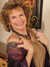 54 year old Judy strips out of her nylons and spreads her legs